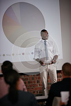 Delivering an exciting new business course. Shot of a businessman giving a presentation to his colleagues.