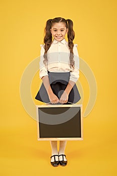 Delivering fresh information. Schoolgirl cheerful pupil informing you. Girl school uniform hold blackboard. Back to