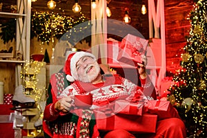 Delivering gifts. Santa Claus near christmas tree. Merry christmas. Bearded senior man Santa Claus. Santa Claus relaxing