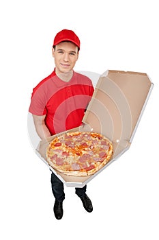 Delivering pizza. Top view of cheerful young deliveryman holding