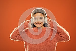 Delivering sound right to her ears with headphones. Small child listening to music in wireless headphones. Little girl