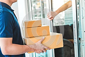 Delivery Asian man service with boxes in hands standing in front of Customer`s house doors