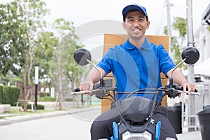 Delivery boy on motorcycle with trunk parcel box driving to fast in rush. Courier delivering order online.