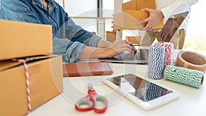 Delivery business Small and Medium EnterpriseSMEs Workers packaging box In Distribution Warehouse home office for shipping to