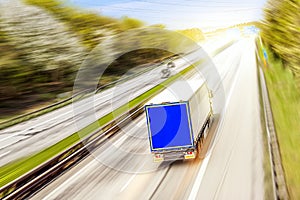 Truck moves on the road at speed, delivery of goods.
