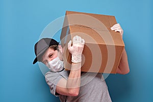 Delivery caucasian man carrying a heavy parcel box