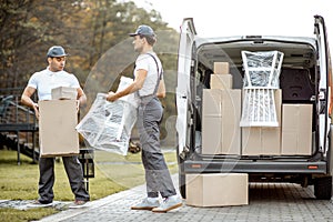 Delivery company employees unloading cargo van vehicle