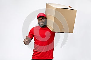 Delivery Concept - Handsome African American delivery man carrying package box. Isolated on Grey studio Background. Copy photo