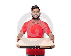 Delivery Concept: Handsome pizza delivery man courier in red uniform with cap holding pizza boxes isolated on white background