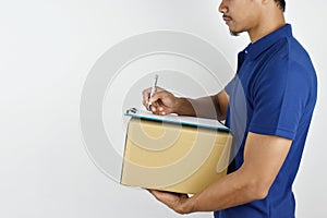 Delivery concept. portrait of delivery man holding parcel box for customer services and writing customer list on a clipboard on