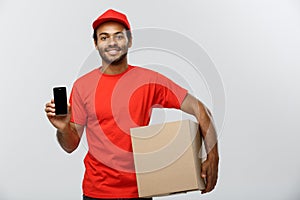 Delivery Concept - Portrait of Handsome African American delivery man or courier with box showing mobile phone on you to