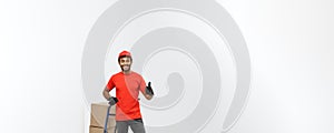 Delivery Concept - Portrait of Handsome African American delivery man or courier pushing hand truck with stack of boxes