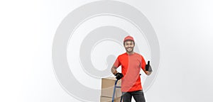 Delivery Concept - Portrait of Handsome African American delivery man or courier pushing hand truck with stack of boxes