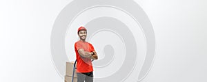 Delivery Concept - Portrait of Handsome African American delivery man or courier pushing hand truck with stack of boxes