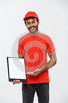 Delivery Concept - Portrait of Handsome African American delivery man or courier showing a confirmation document form to