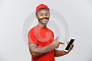 Delivery Concept - Portrait of Handsome African American delivery man or courier showing tablet on you to check the