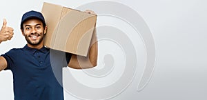 Delivery Concept - Portrait of Happy African American delivery man holding a box package and showing thumps up. Isolated