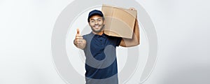 Delivery Concept - Portrait of Happy African American delivery man holding a box package and showing thumps up. Isolated