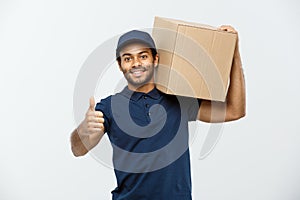 Delivery Concept - Portrait of Happy African American delivery man holding a box package and showing thumps up. Isolated