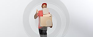 Delivery Concept - Portrait of Happy African American delivery man holding box packages and showing thumps up. Isolated