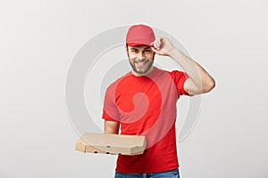 Delivery Concept: Young haapy caucasian Handsome Pizza delivery man holding pizza boxes isolated over grey background