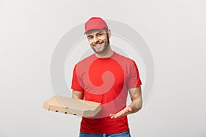 Delivery Concept: Young haapy caucasian Handsome Pizza delivery man holding pizza boxes isolated over grey background