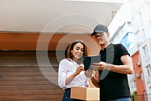 Delivery Courier. Man Delivering Package To Woman