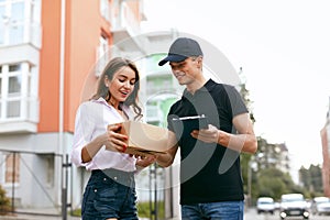 Delivery Courier. Man Delivering Package To Woman