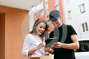 Delivery Courier. Man Delivering Package To Woman