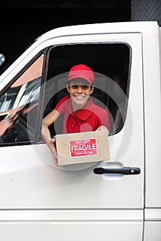 Delivery courier in truck with package
