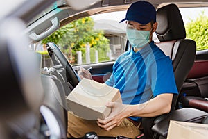 Delivery courier young man driver inside the van car with parcel post boxes checking amount
