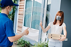 Delivery express of asian woman picking pizza fast food social distancing thumbs up