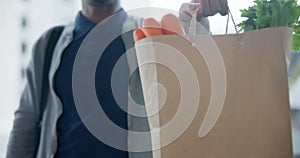 Delivery, food and bag with a man courier at the front door of a home to drop off produce for a customer. Grocery