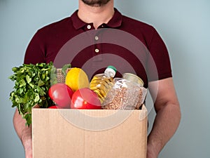 Delivery Food Concept. Delivery man in uniform carrying food box from store