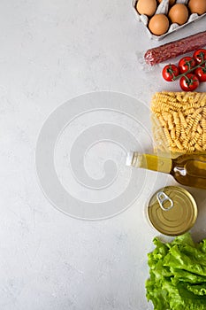 Delivery of food products during the period of isolation. Food supplies from an online store pasta, oil, eggs, salad.