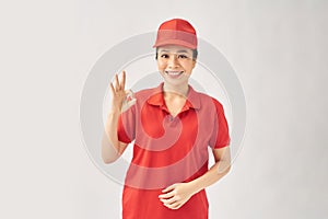 Delivery friendly woman in red uniform isolated on white background