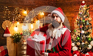 Delivery gifts. Gift emotions. Santa man holding gift. Merry Christmas and Happy Holidays. Christmas Santa.