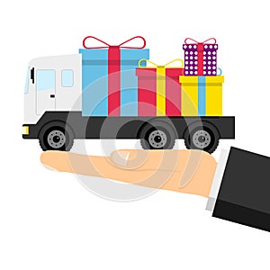 Delivery of gifts, a man holds a truck with boxes of gifts in the palm of his hand. Vector illustration.