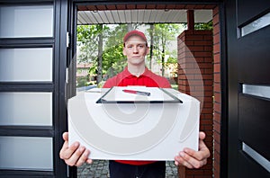 Delivery guy handing in parcel photo