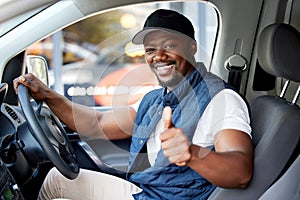 Delivery guy, transport or man driving with thumbs up, shipping or courier service. Happy black person, portrait or