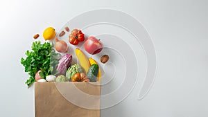 Delivery healthy food background. Healthy vegan vegetarian food in paper bag vegetables and fruits on white, copy space, banner.