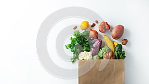 Delivery healthy food background. Healthy vegan vegetarian food in paper bag vegetables and fruits on white, copy space, banner.