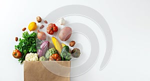 Delivery healthy food background. Healthy vegan vegetarian food in paper bag vegetables and fruits on white, copy space, banner.