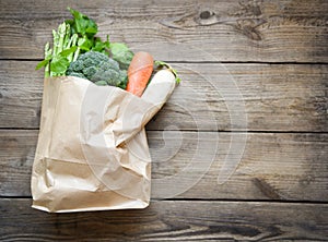 Delivery healthy food in paper bag grocery shopping concept  Fresh vegetable from market take away paper bag shopping on wooden