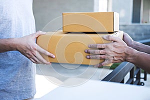 Delivery mail man giving parcel box to recipient, Young owner accepting of cardboard boxes package from post shipment, Home