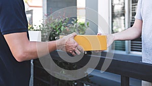 Delivery mail man giving parcel box to recipient, Young owner accepting of cardboard boxes package from post shipment, Home