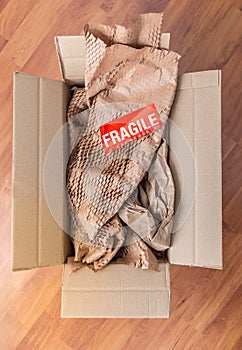 Delivery and mail service, people and shipment concept - fragile mark in parcel box