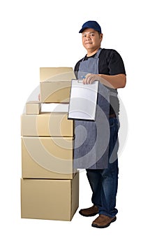 Delivery man in Black shirt and apron with stack of boxes is carrying parcel and presenting receiving form isolated
