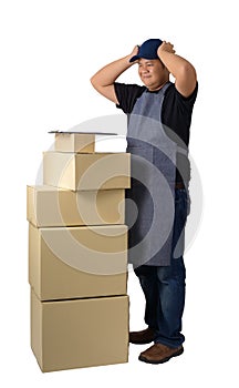 Delivery man in Black shirt and apron with stack of boxes isolated