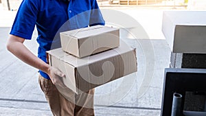 Delivery man in blue uniform handing parcel box for client  signing checklist after confirm receiving package